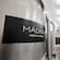 A large stainless steel tank with the words Madara Organic Skincare next to workers attending another nearby tank